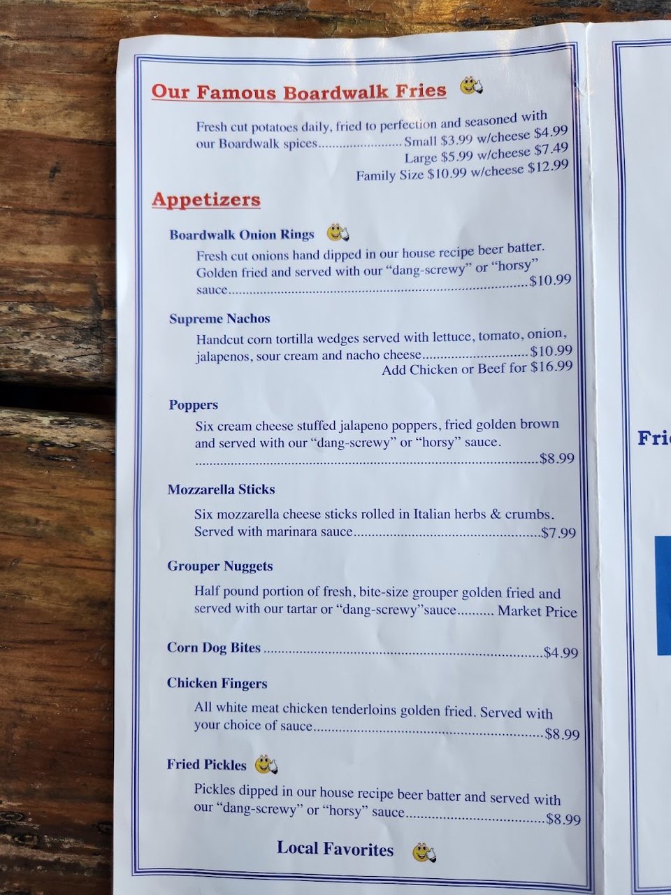 Printed menu with seafood and burgers.